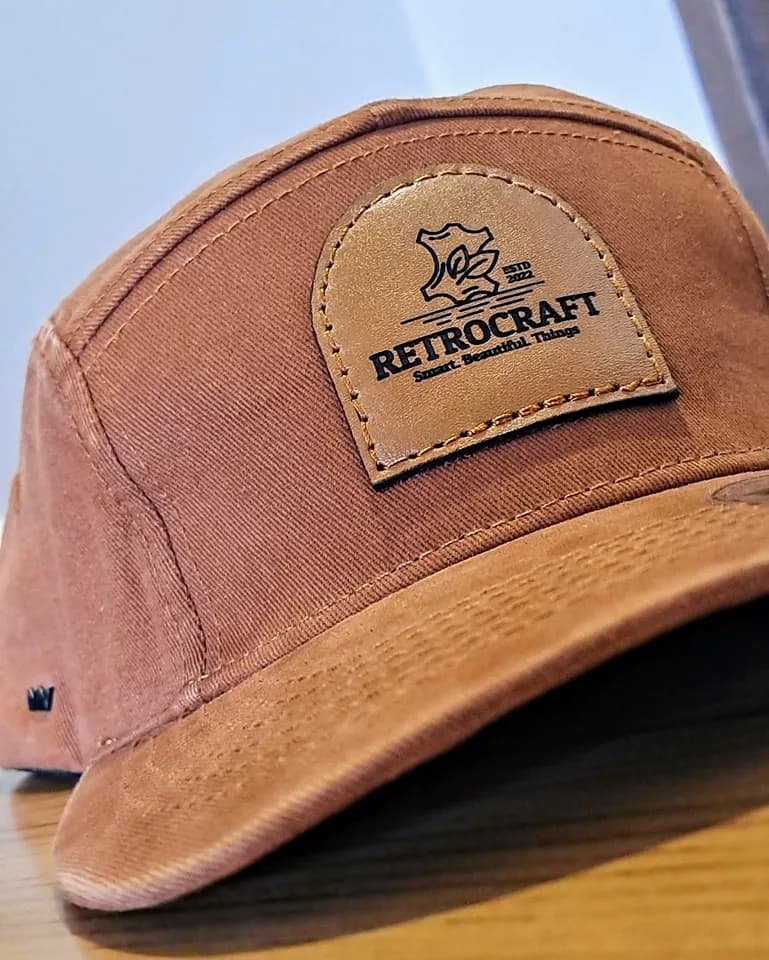 Rectangular leather patch on a tan cap