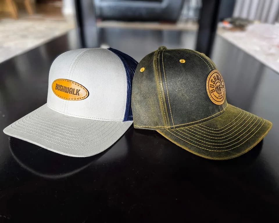 Two trucker caps, white and olive, with leather patches